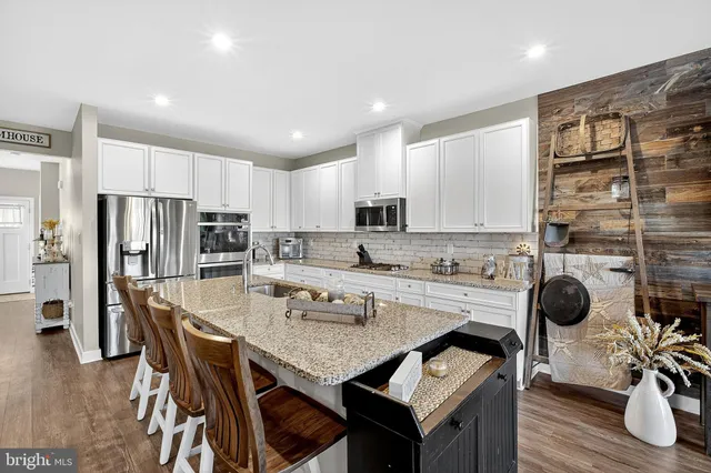 a view of a workspace with furniture and a flat screen tv