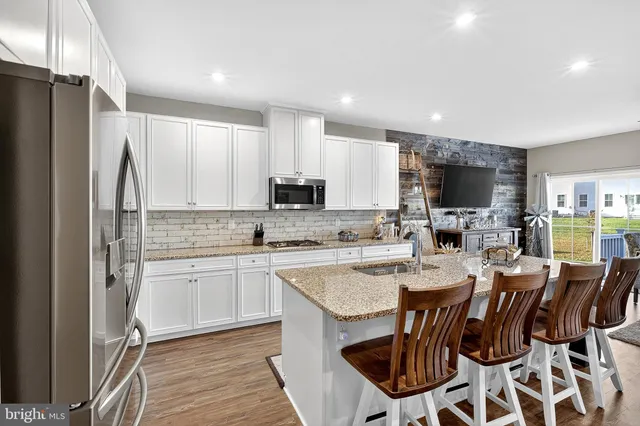 a bedroom with a bed and a lamp on dresser