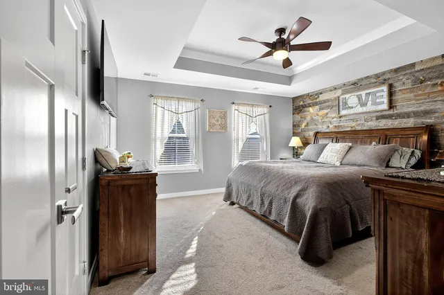 a room with table chairs and kitchen view