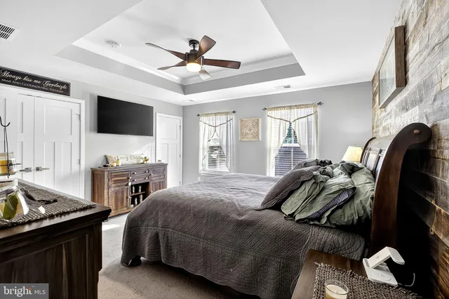 a living room with furniture a flat screen tv and kitchen view