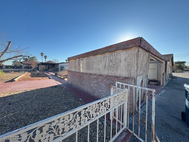 1275 Westwind Road Las Vegas, NV 89146 - Photo 29 of 30 View of property exterior featuring brick siding
