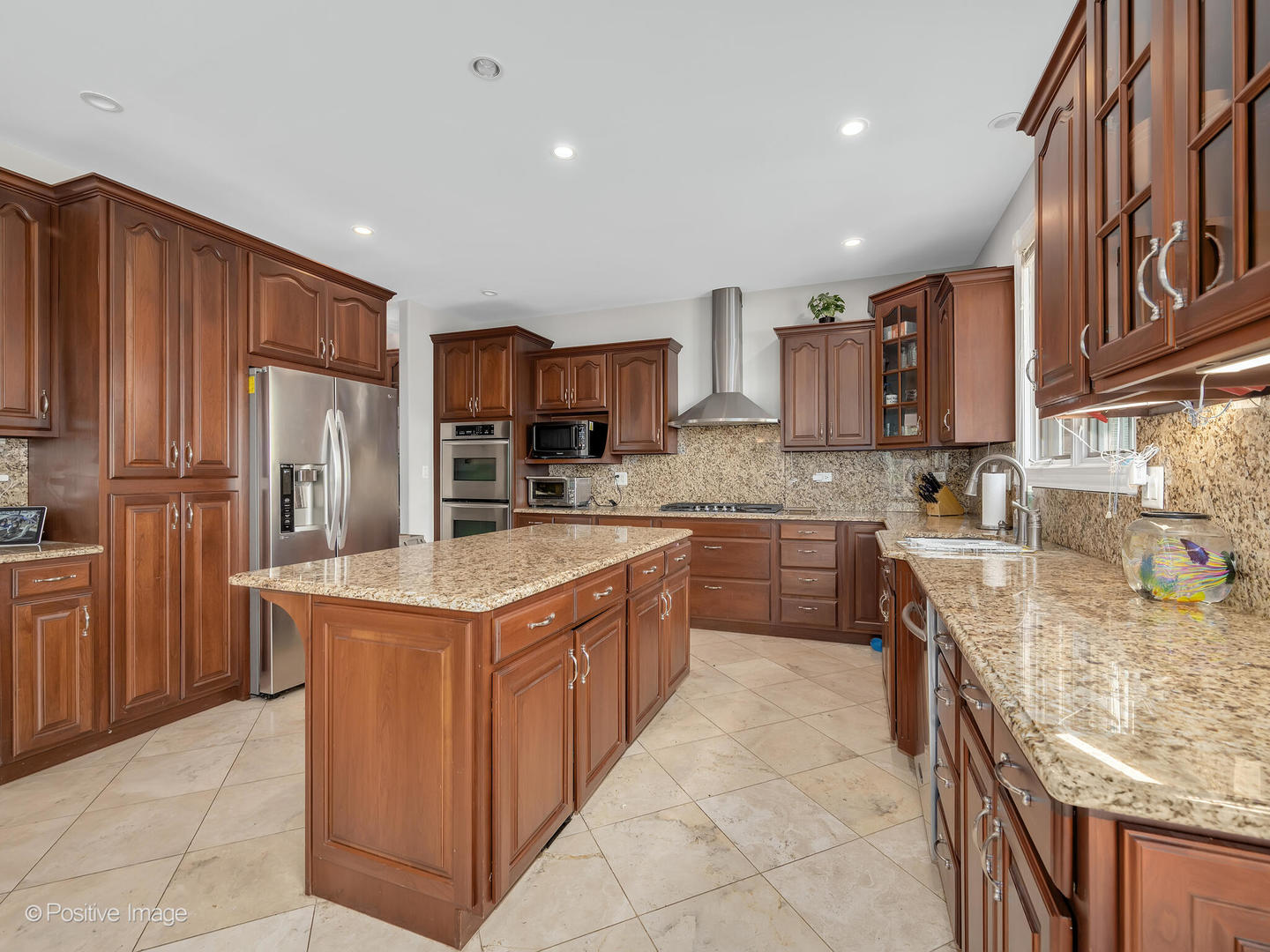 2804 Central Road Glenview, IL 60025 - Photo 13 of 41 a kitchen with kitchen island granite countertop stainless steel appliances a sink a stove and a refrigerator
