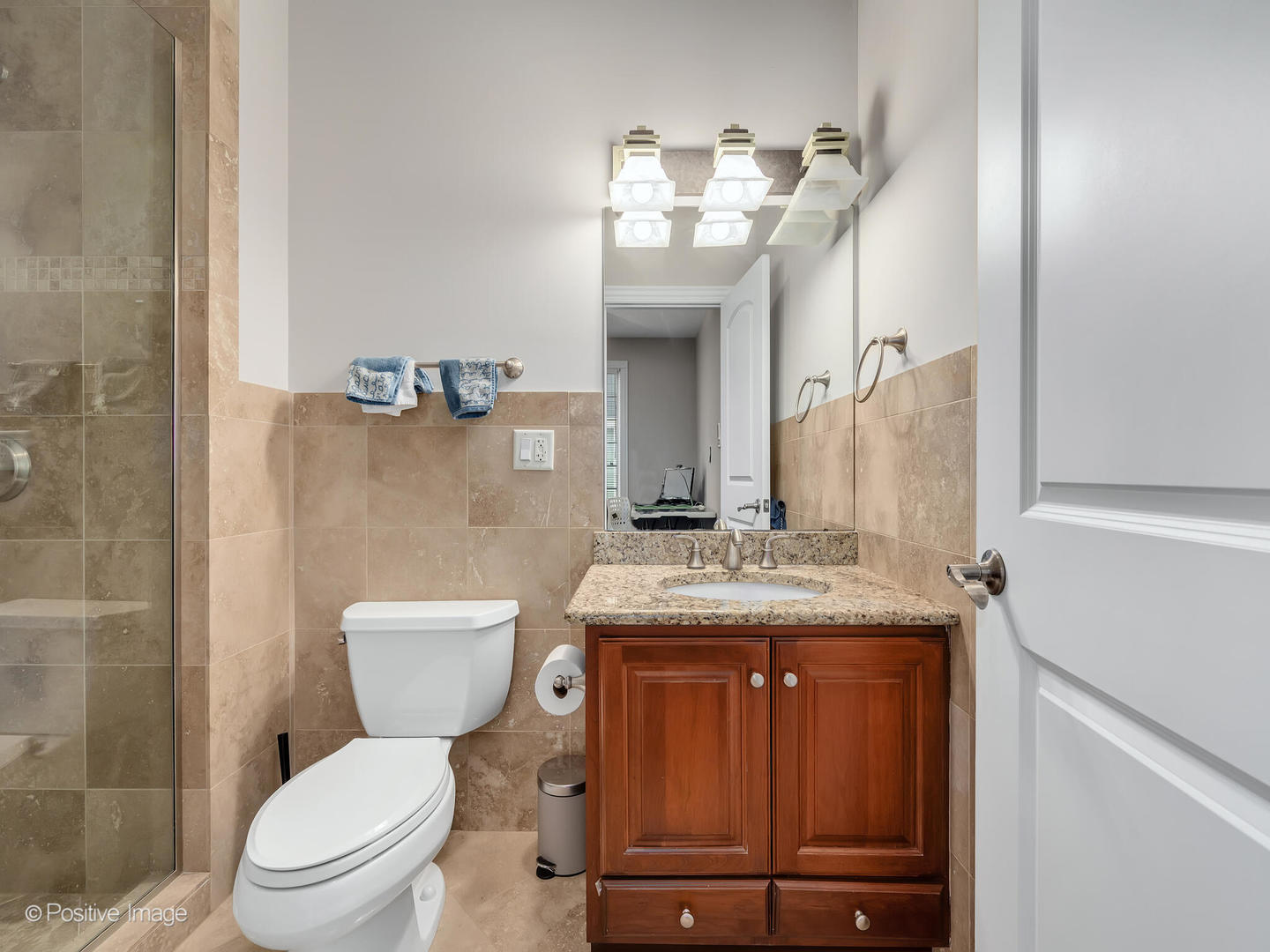 2804 Central Road Glenview, IL 60025 - Photo 30 of 41 a bathroom with a granite countertop toilet sink and mirror