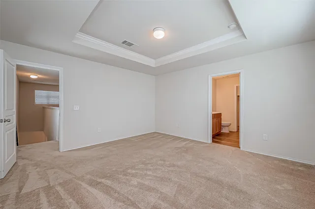 an empty room with closet and a bathroom