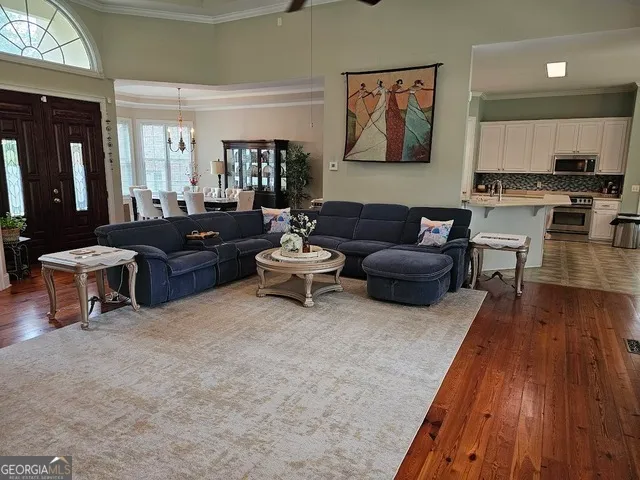 a living room with furniture and wooden floor