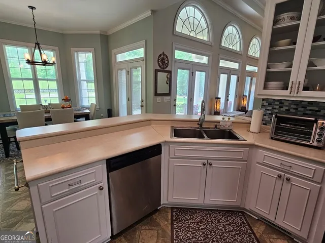 a kitchen with stainless steel appliances a sink stove and cabinets