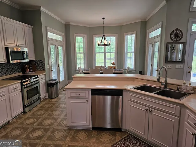 a kitchen with stainless steel appliances granite countertop a sink stove and cabinets