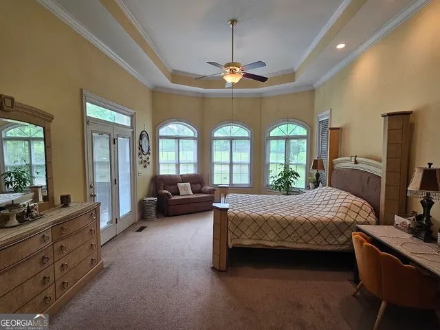 a bedroom with bed and glass windows