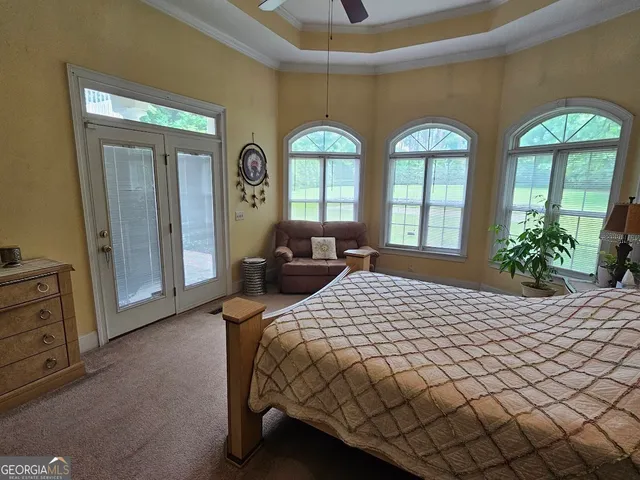 a bedroom with a bed mirror and window