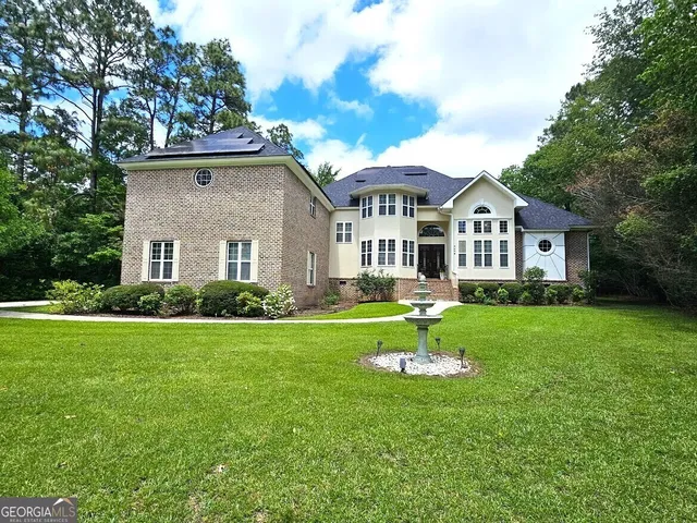 a front view of a house with a yard table and trees