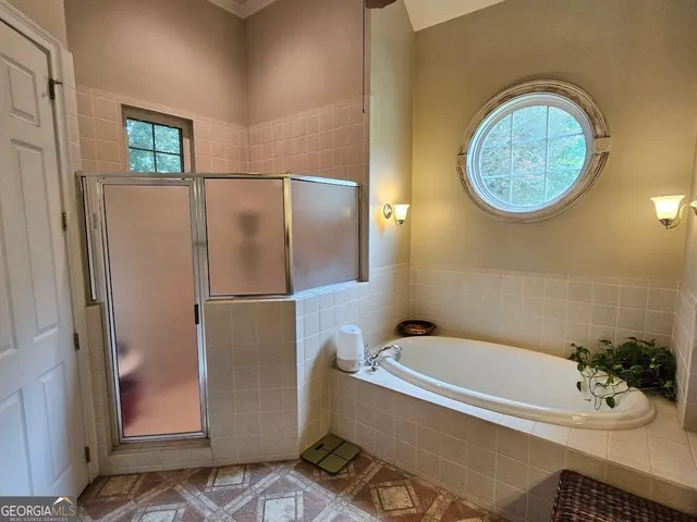 a bathroom with a tub and a shower