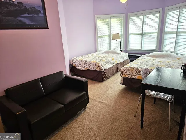 a bedroom with bed and window