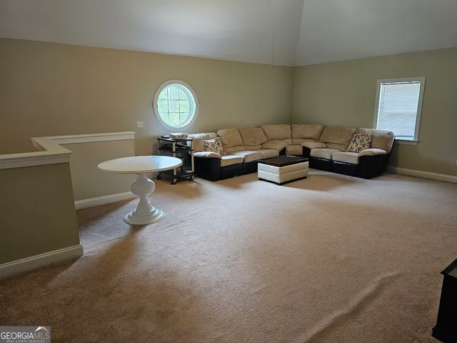 a living room with furniture a lamp and a window
