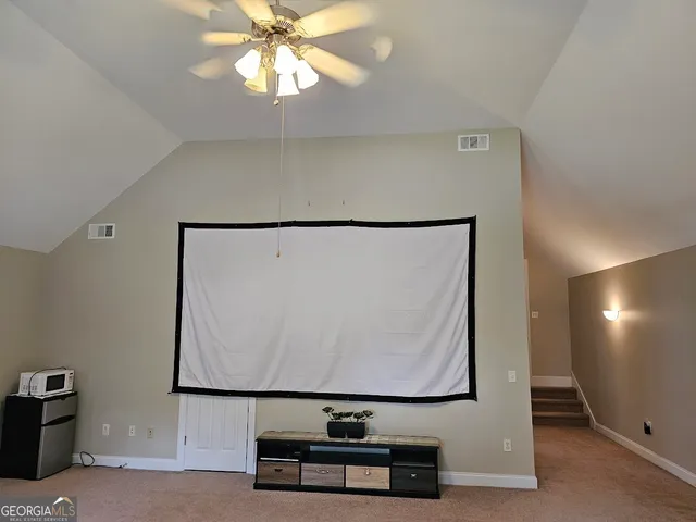 a picture of a room with wooden floor and cabinet