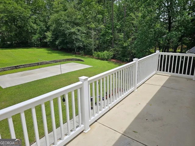 a view of a balcony with a small yard