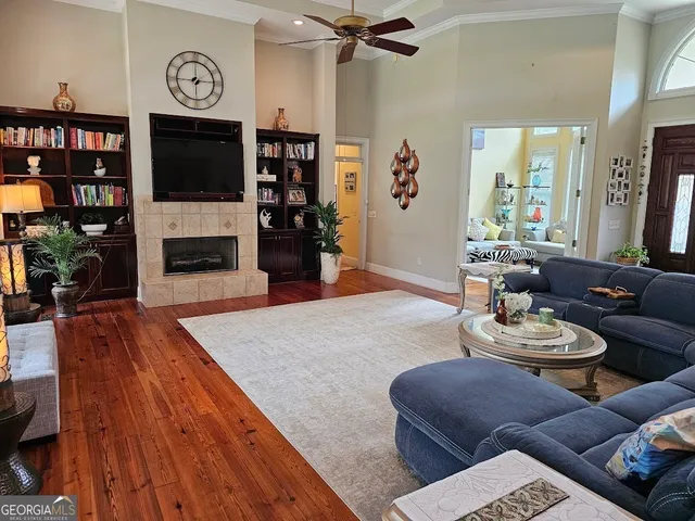 a living room with fireplace furniture and a flat screen tv