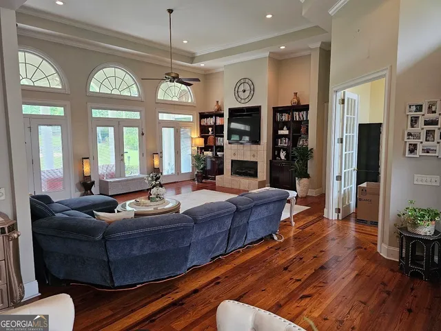 a living room with furniture a fireplace and a chandelier
