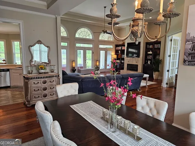 a living room with furniture a fireplace and a chandelier