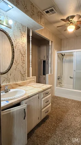 a bathroom with a double vanity sink mirror and shower