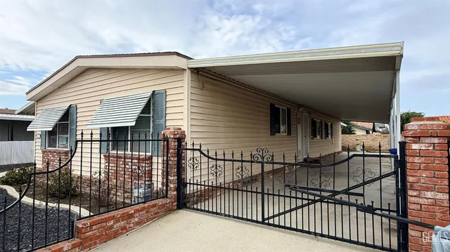 a view of a house with iron fence