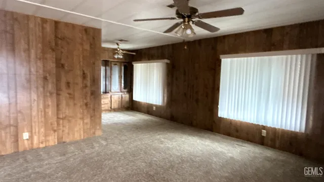 a view of a livingroom with a ceiling fan and window