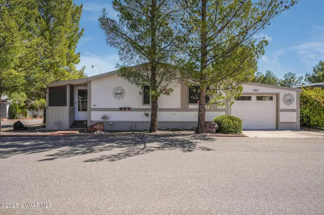 a view of a house with a yard and garage