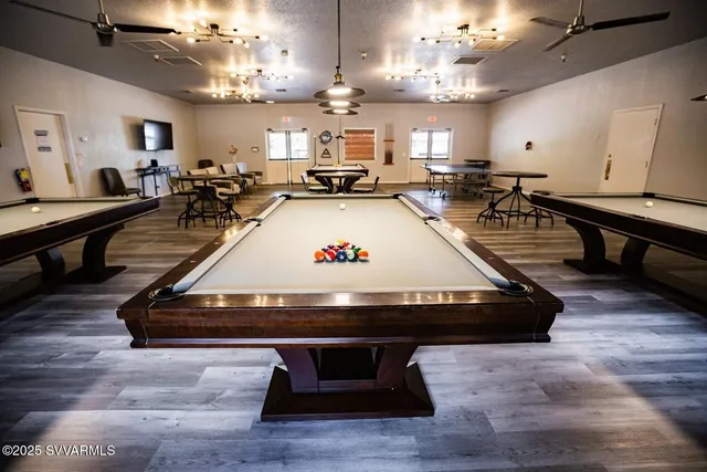 a living room with lots of furniture and view of kitchen
