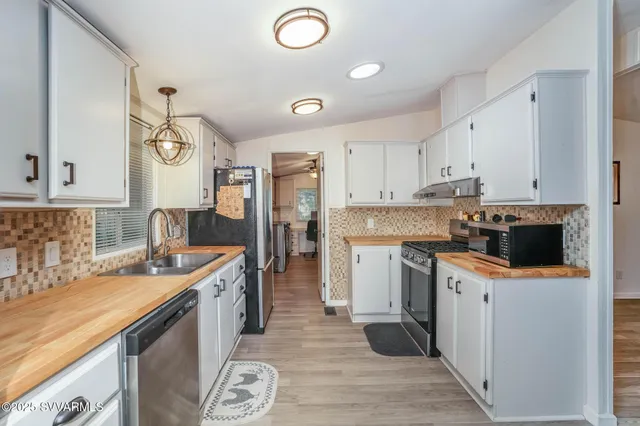 a kitchen with a sink stove and refrigerator