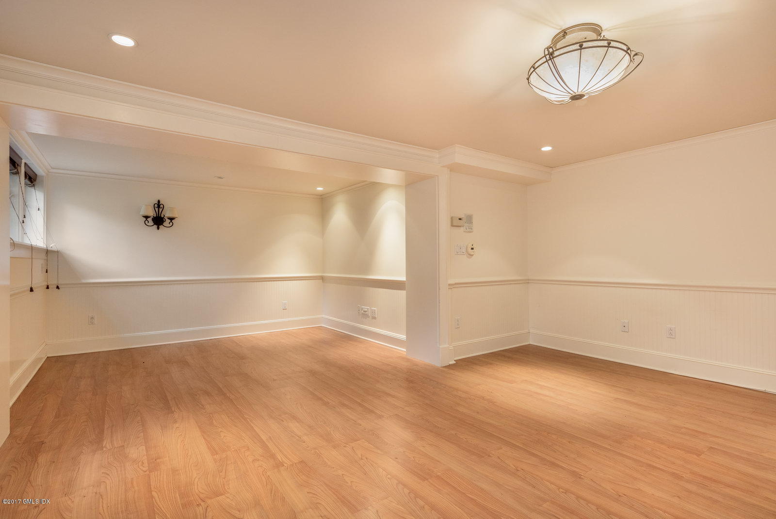 54 Valleywood Road Cos Cob, CT 06830 - Photo 16 of 26 an empty room with wooden floor and white walls
