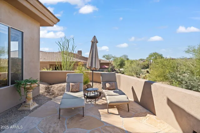 a backyard of a house with barbeque oven and outdoor seating