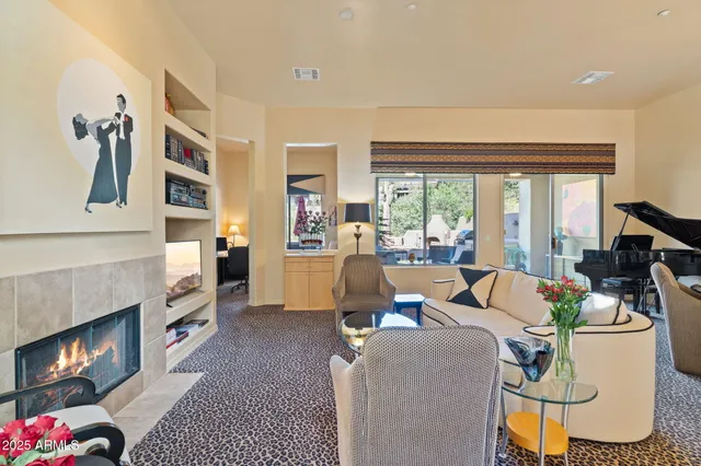 a living room with furniture and a painting on the wall