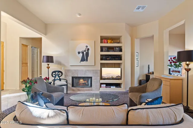 a living room with fireplace furniture and a flat screen tv