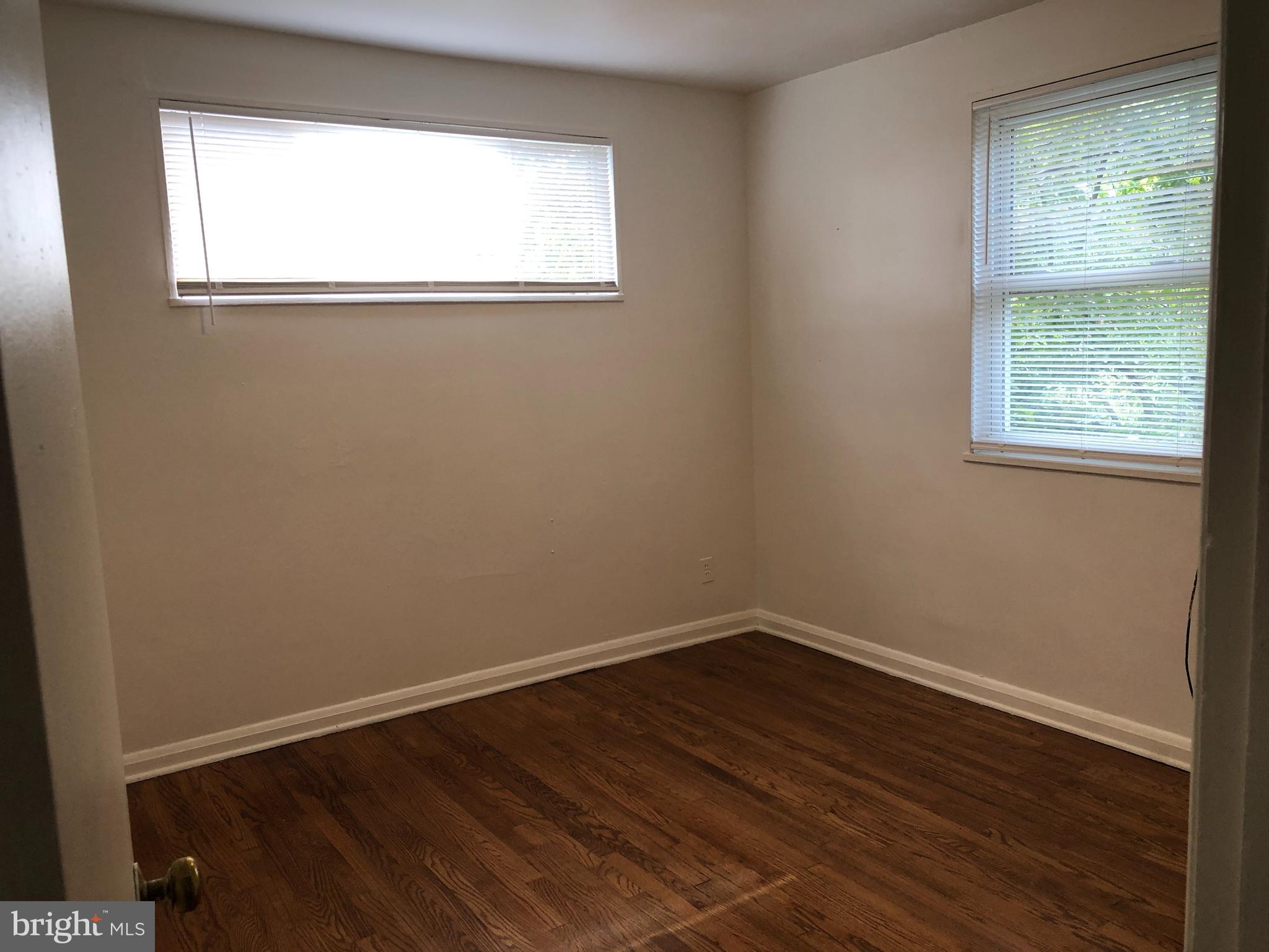 3810 Bancroft Road Baltimore, MD 21215 - Photo 16 of 19 a view of a small space with wooden floor and a window