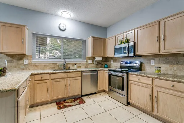 a kitchen with a sink window and cabinets