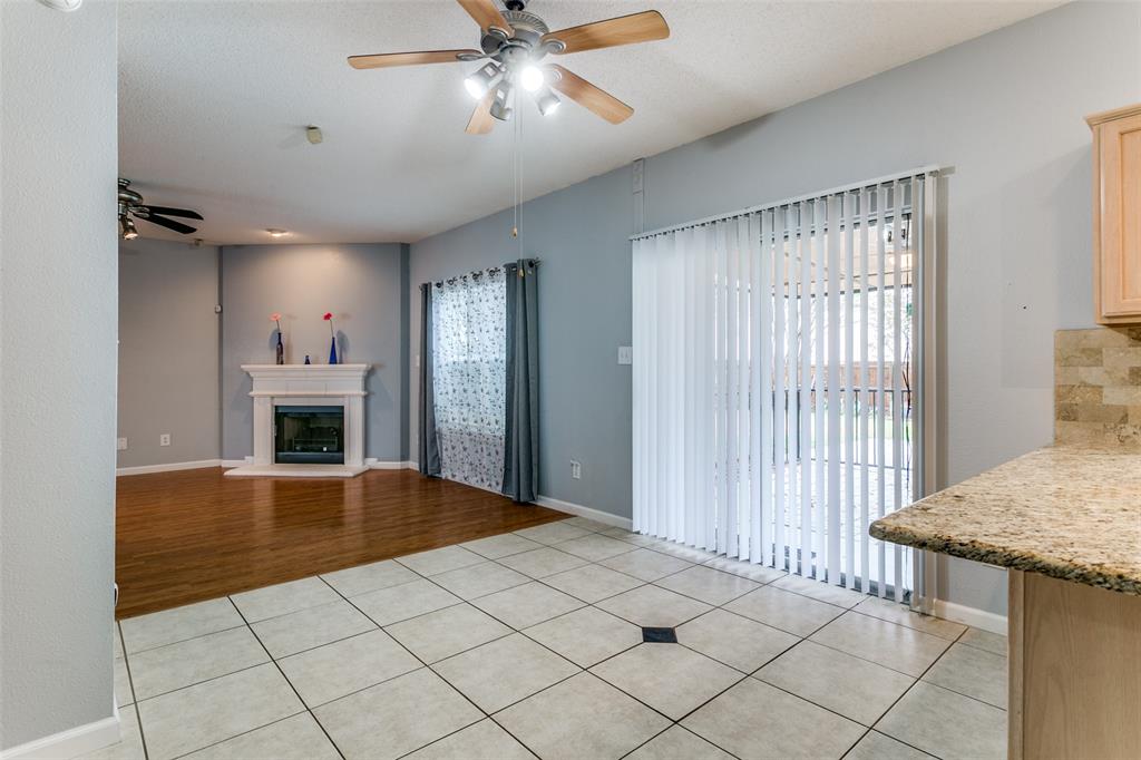 307 Pointer Place Arlington, TX 76002 - Photo 13 of 25 a view of a livingroom with a fireplace a chandelier a ceiling fan and wooden floor