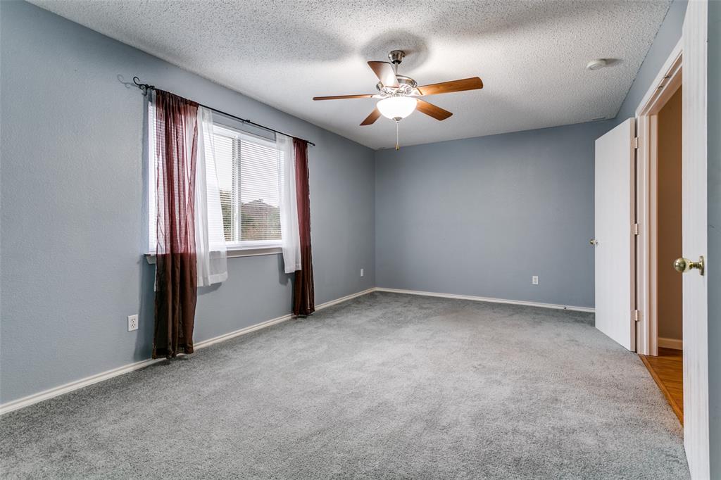 307 Pointer Place Arlington, TX 76002 - Photo 19 of 25 an empty room with windows and chandelier fan