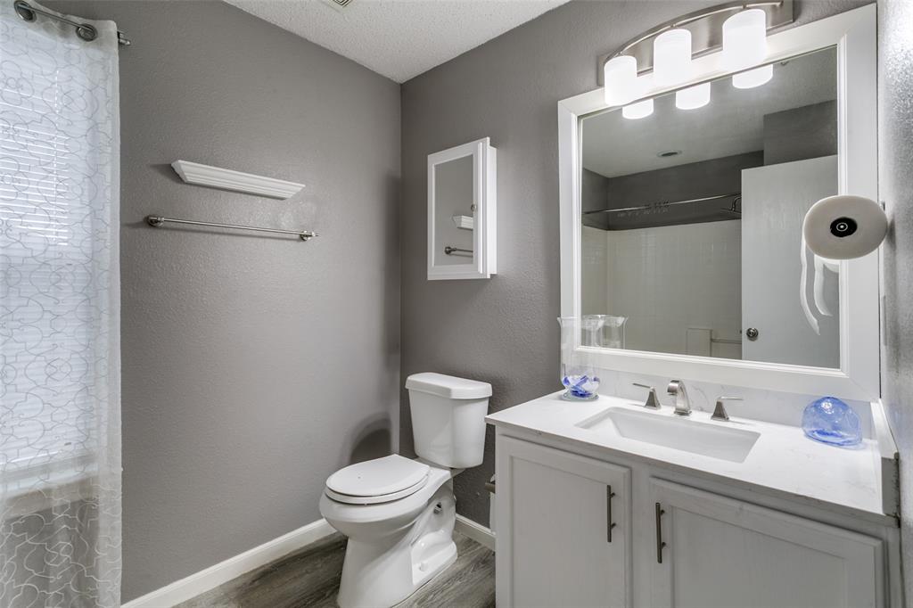 307 Pointer Place Arlington, TX 76002 - Photo 21 of 25 a bathroom with a toilet sink and mirror