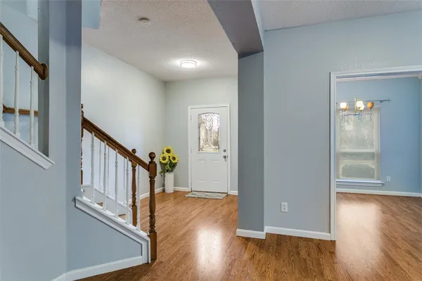a view of an entryway with wooden floor