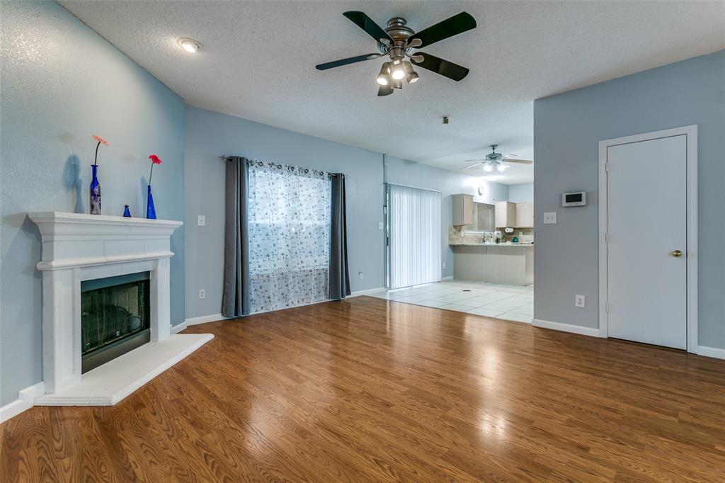307 Pointer Place Arlington, TX 76002 - Photo 9 of 25 a view of empty room with wooden floor and fireplace