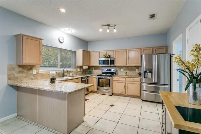 a kitchen with a sink stove and refrigerator