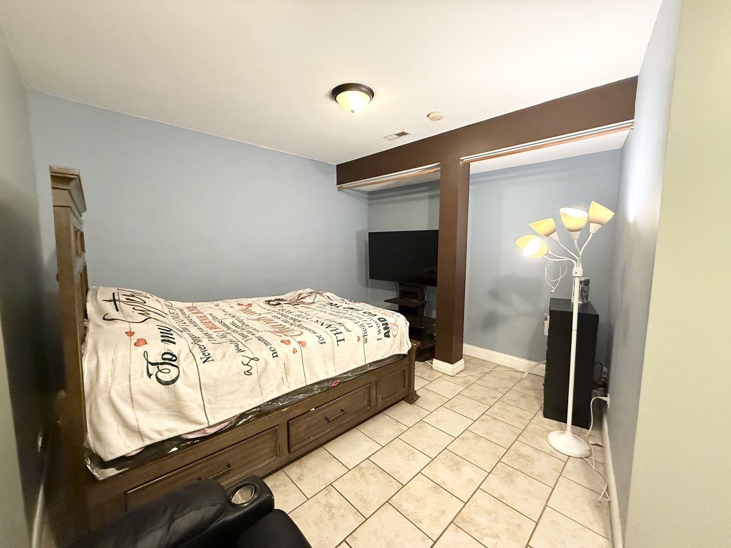 6035 South St Lawrence Avenue, Unit GS Chicago, IL 60637 - Photo 12 of 17 a bedroom with a bed and a mirror