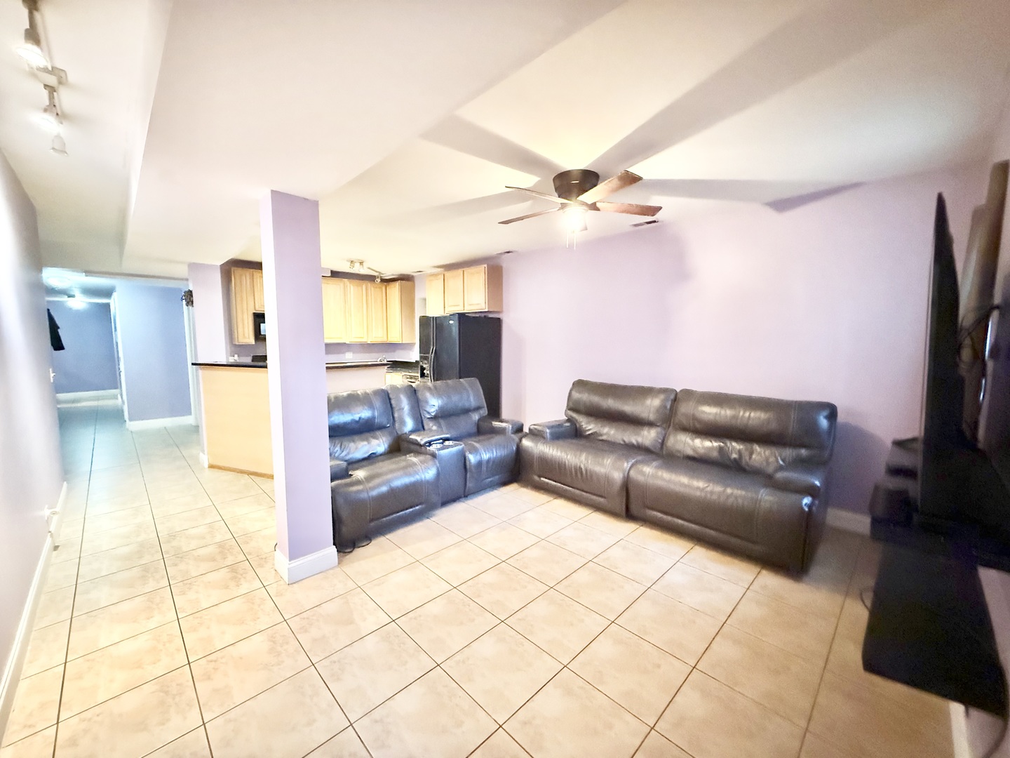 6035 South St Lawrence Avenue, Unit GS Chicago, IL 60637 - Photo 7 of 17 a living room with a couch and a flat screen tv