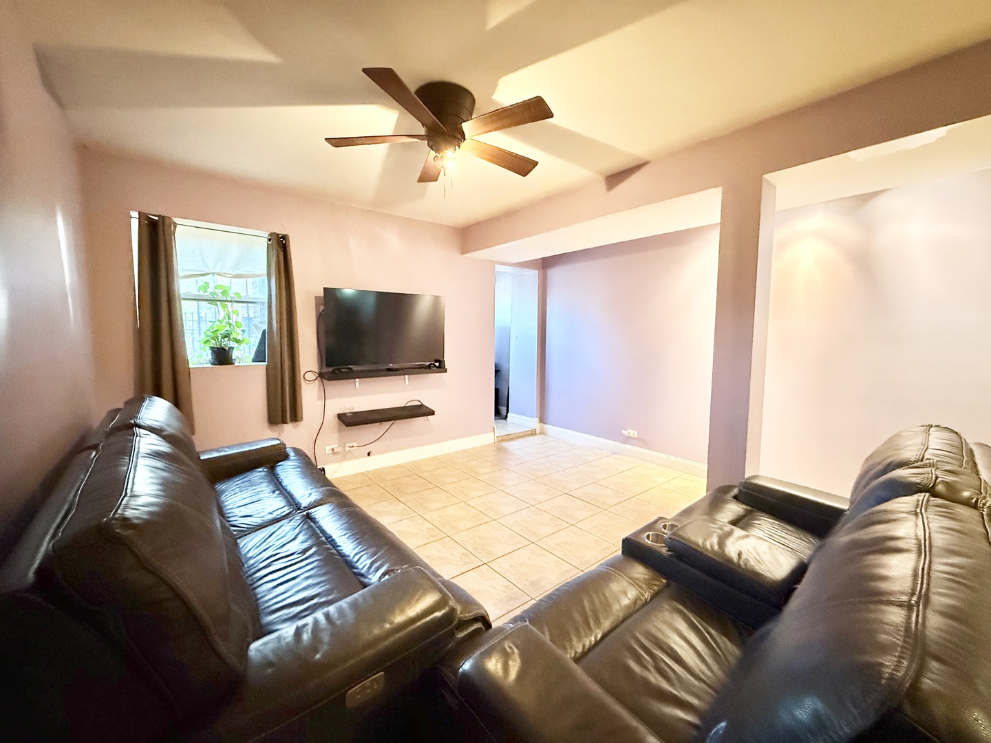 6035 South St Lawrence Avenue, Unit GS Chicago, IL 60637 - Photo 9 of 17 a living room with furniture and a flat screen tv