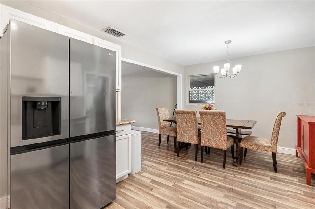398 Rose Street Umatilla, FL 32784 - Photo 12 of 30 a view of a dining room with furniture and wooden floor