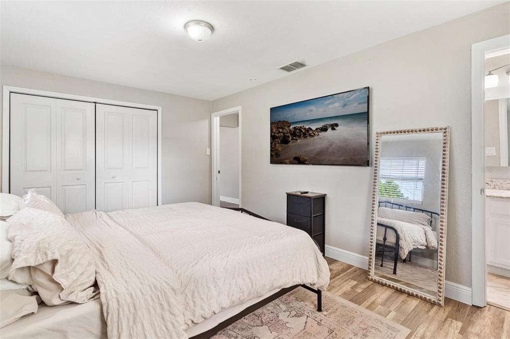 398 Rose Street Umatilla, FL 32784 - Photo 15 of 30 a bedroom with a bed and a flat screen tv