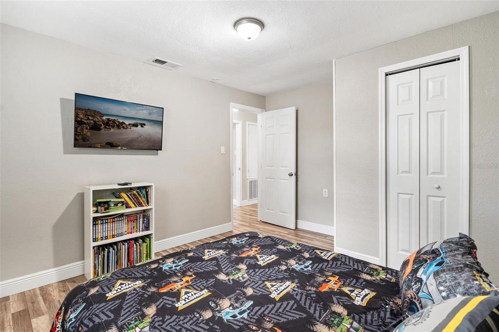 398 Rose Street Umatilla, FL 32784 - Photo 18 of 30 a bedroom with bed and walk in closet