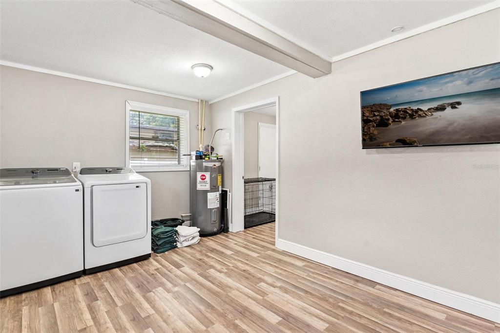 398 Rose Street Umatilla, FL 32784 - Photo 25 of 30 a storage room with cabinets washer and dryer
