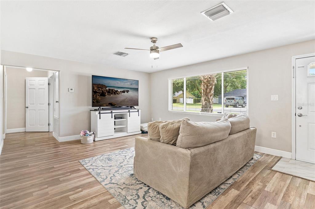 398 Rose Street Umatilla, FL 32784 - Photo 5 of 30 a living room with furniture and a flat screen tv