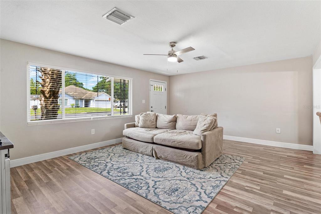 398 Rose Street Umatilla, FL 32784 - Photo 6 of 30 a living room with furniture and a large window