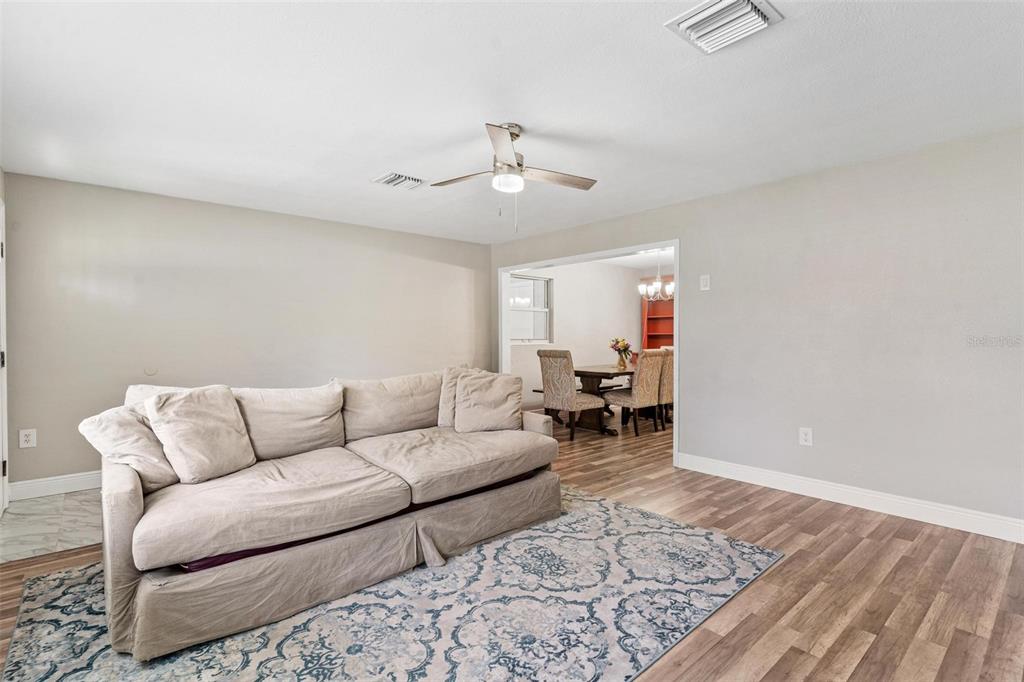 398 Rose Street Umatilla, FL 32784 - Photo 7 of 30 a living room with furniture and a rug